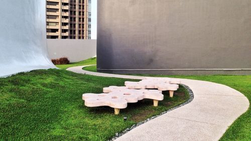 Stone wall in park by building in city