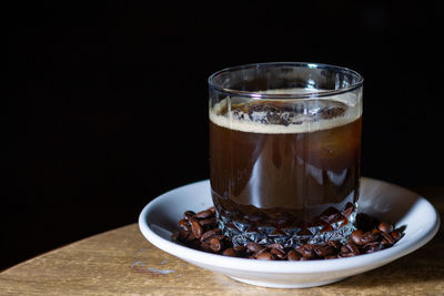 Close-up of coffee in glass on table