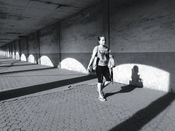 Man running on walkway in city