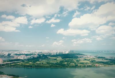 Scenic view of sea and cityscape against sky