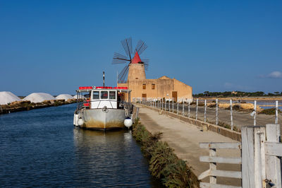 Ship in water against clear blue sky