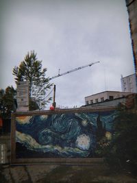 Graffiti on building against sky