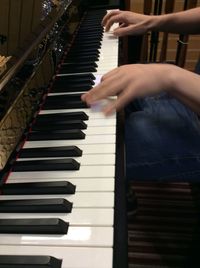 Close-up of man playing piano