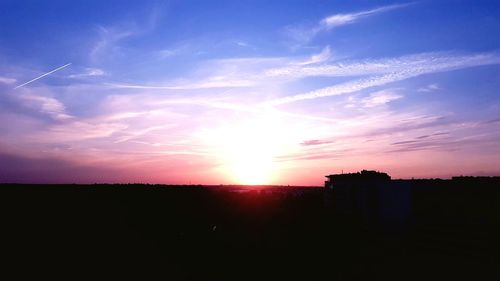 Silhouette landscape against sky during sunset