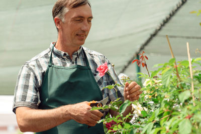 Midsection of man holding plant