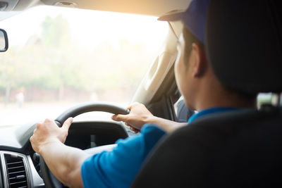 Rear view of man driving car