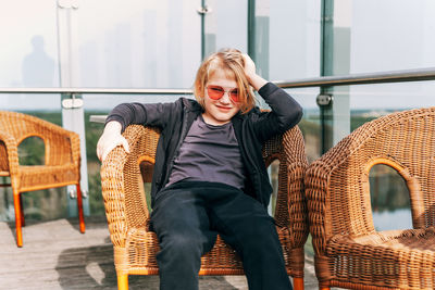 Young woman sitting on sofa at home