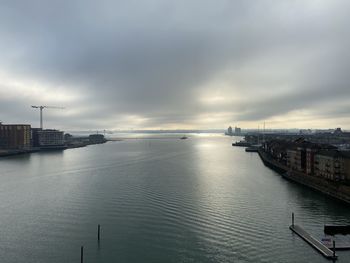 High angle view of city by sea against sky