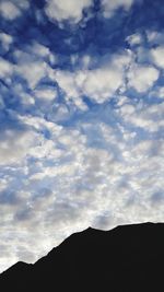 Low angle view of silhouette mountain against sky