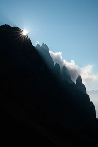 Low angle view of silhouette mountains against sky