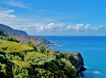 Scenic view of sea against blue sky