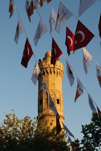 Low angle view of flags hanging against sky