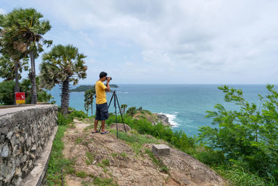 Man standing by sea against sky