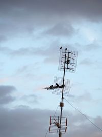 Low angle view of communications tower against sky