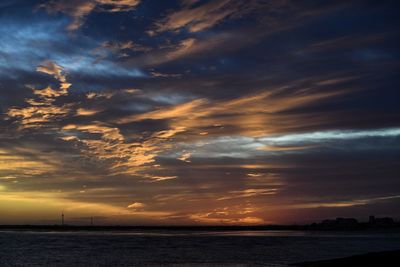 Scenic view of dramatic sky over sea during sunset