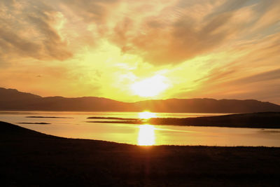 Scenic view of lake against sky during sunset