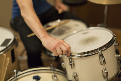 Young musician adjusting his drum kit