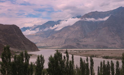 Scenic view of lake and mountains against sky