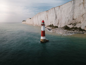 Aerial scenic photo of beachy head lighthouse and seven sisters cliffs in eastbourne united kingdom.