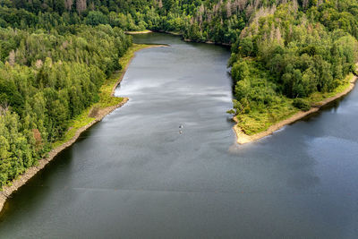 The river bode in the harz region of germany. two people on a zip line above the river.