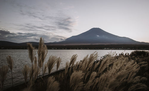 Scenic view of lake and mountains against sky