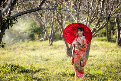 Red umbrella on field during rainy season