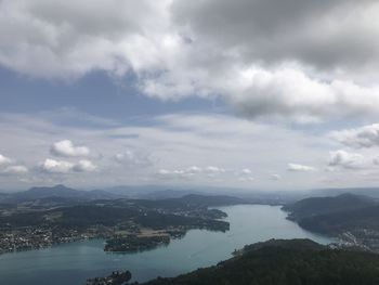 Scenic view of sea and mountains against sky