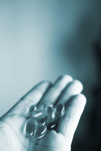 Close-up of human hand holding medicines at home