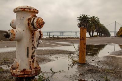 Fire hydrant on beach against sky