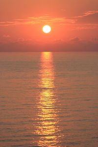 Scenic view of sea against orange sky