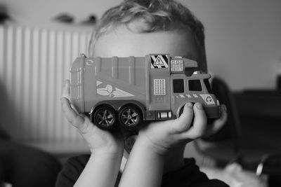 Close-up of boy holding toy car