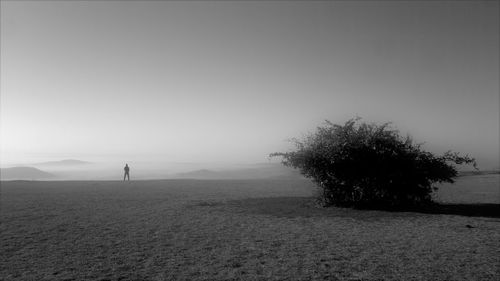 Silhouette of man in desert against sky