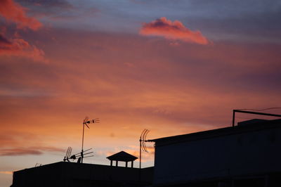 Low angle view of silhouette building against sky during sunset