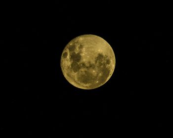 Low angle view of full moon against sky at night