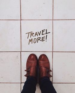 Low section of woman standing on tiled floor