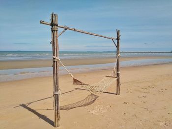 Lifeguard hut on beach against sky