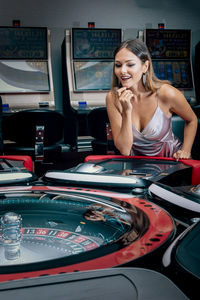 Happy woman playing in casino