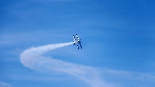 Low angle view of airplane flying in sky