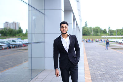 Portrait of businessman standing in city