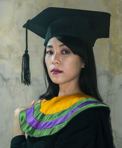 Portrait of woman standing against the wall