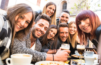 Portrait of smiling friends at outdoor restaurant