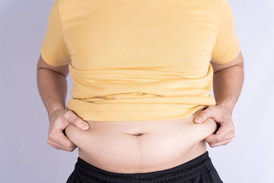 Midsection of a woman against white background