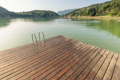 Wooden pontoon at the edge of a lake in the evening at sunset