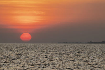 Scenic view of sea against orange sky