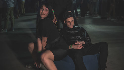 Young couple sitting on wall