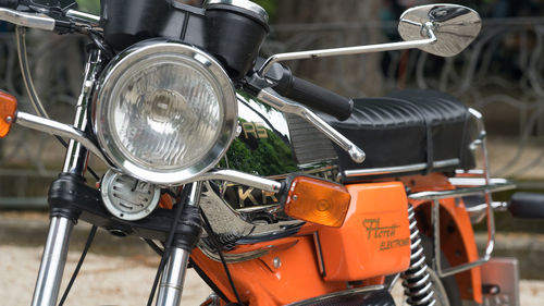 Close-up of bicycle parked on road in city