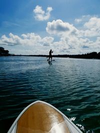 Man on boat in sea against sky