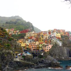 Townscape by sea against clear sky