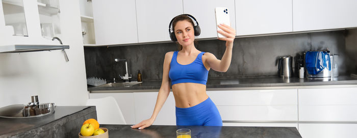 Portrait of young woman exercising in bathroom