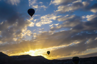 Low angle view of hot air balloons against sky during sunset